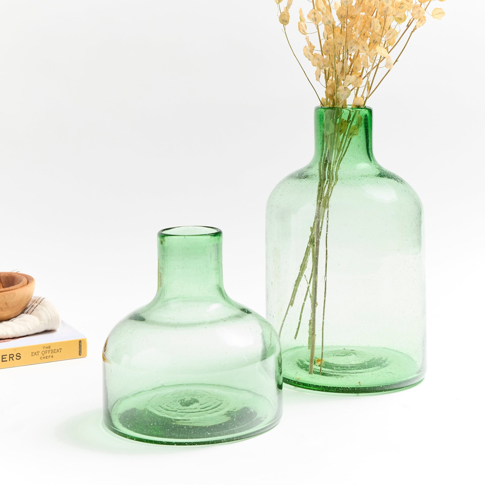 Short green glass vase with tall green glass vase.