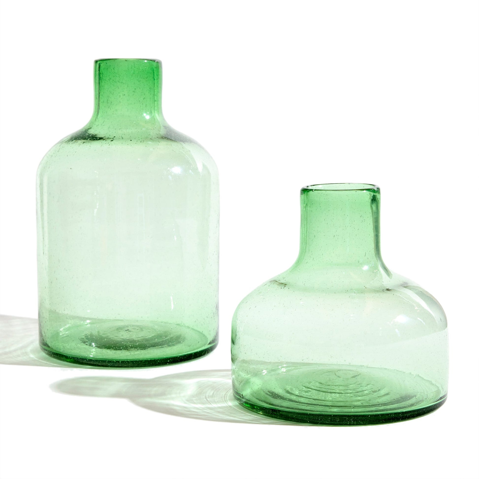 Short green glass vase with tall green glass vase.