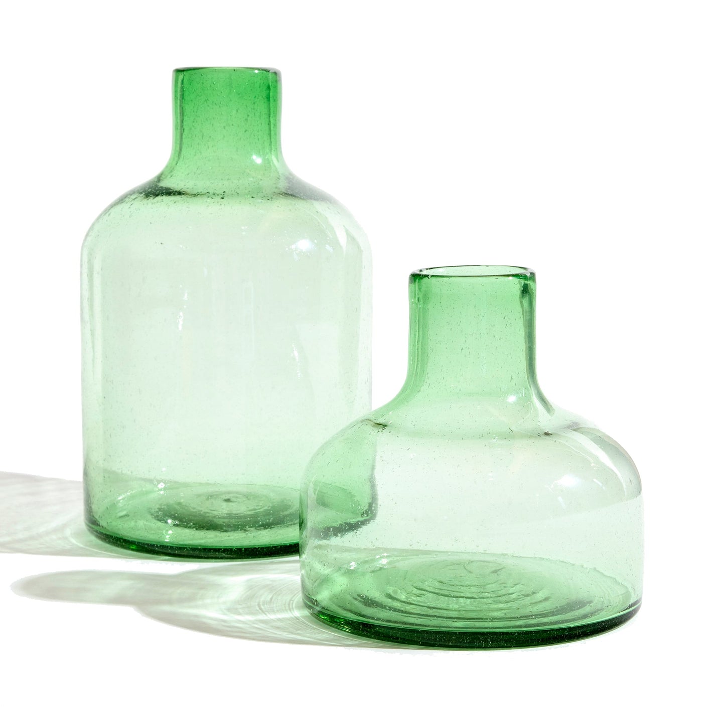 Short green glass vase with tall green glass vase.