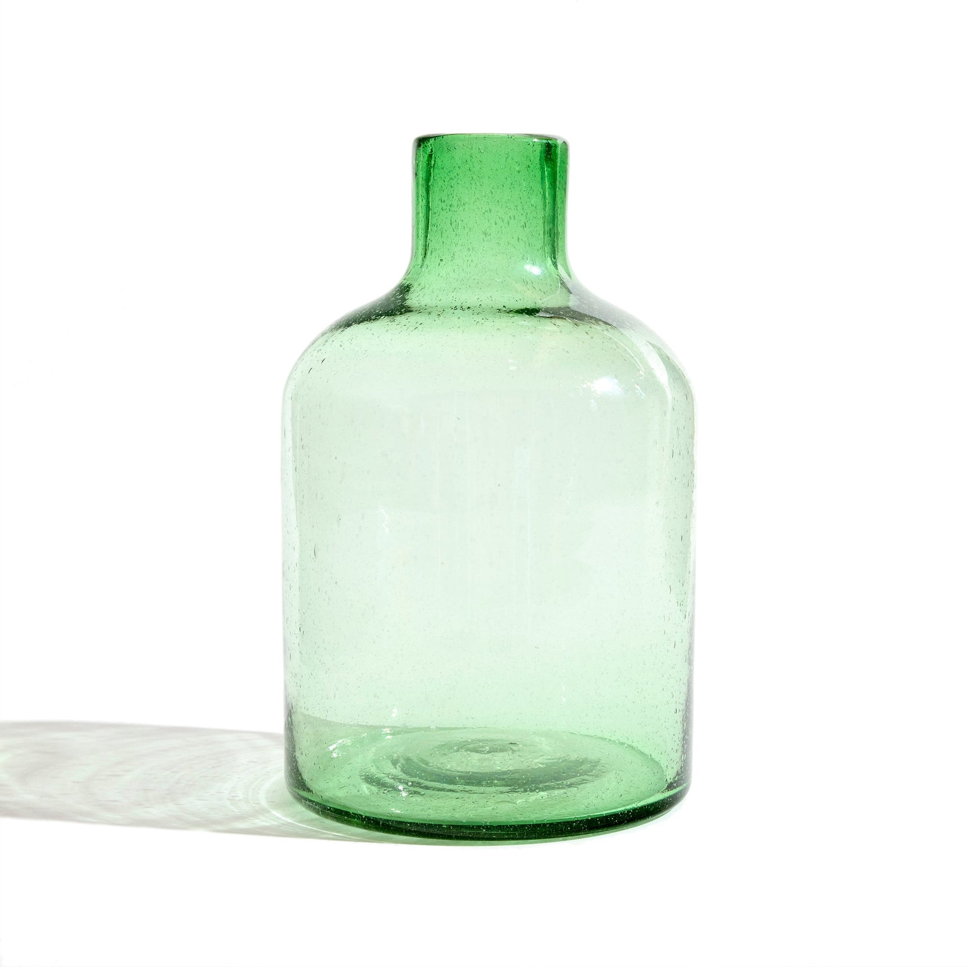 Tall green glass vase.