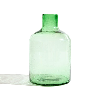 Tall green glass vase.