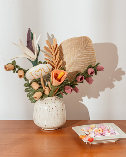 Pink and blush color felt Bellflowers in white vase with other felt flowers.
