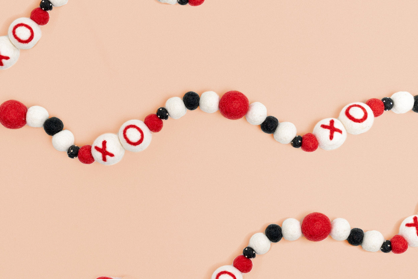 Felt garland with XO and red, white and black balls in between.