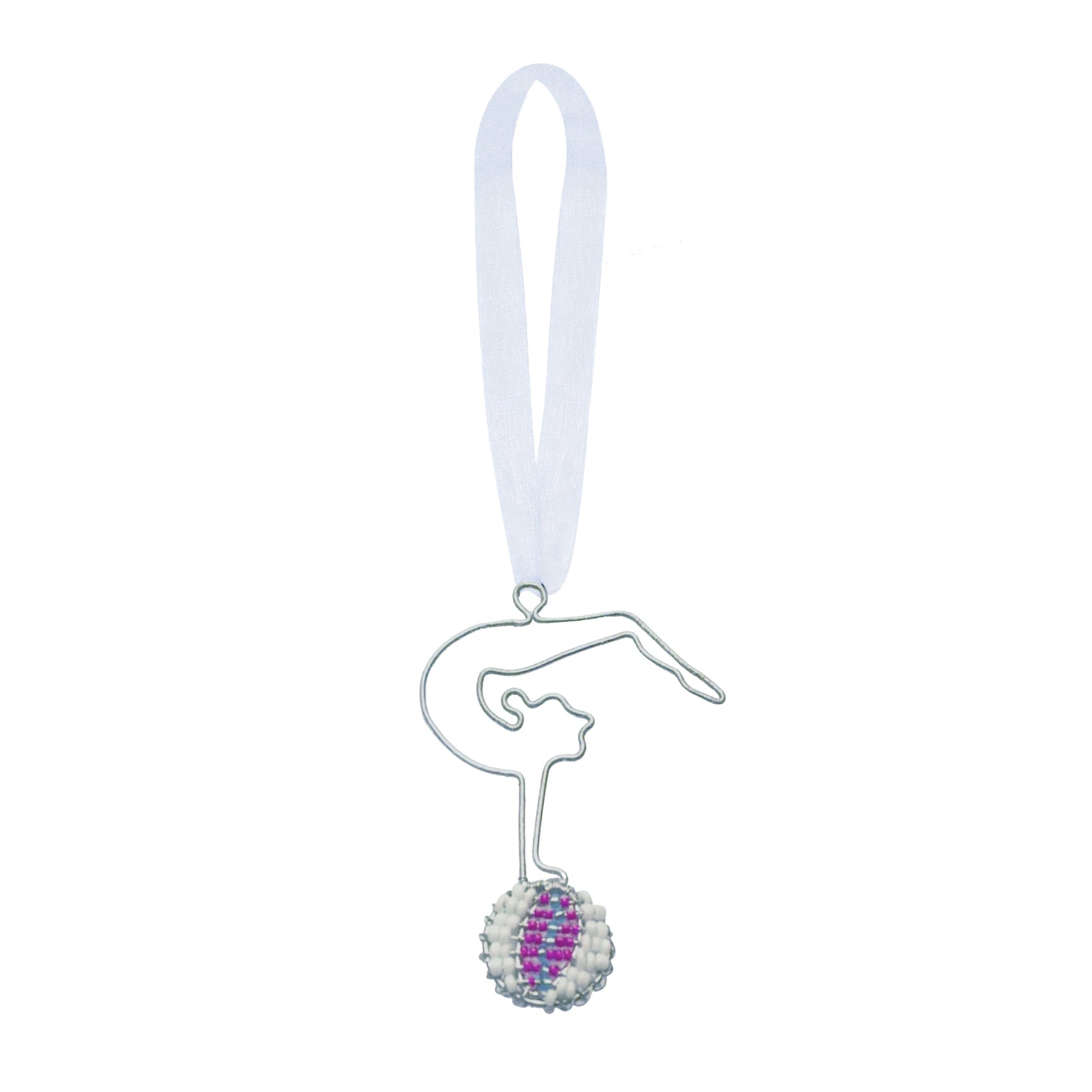 Wire and bead ornament of a circus woman gymnast doing a handstand backbend on a purple and whiteball.