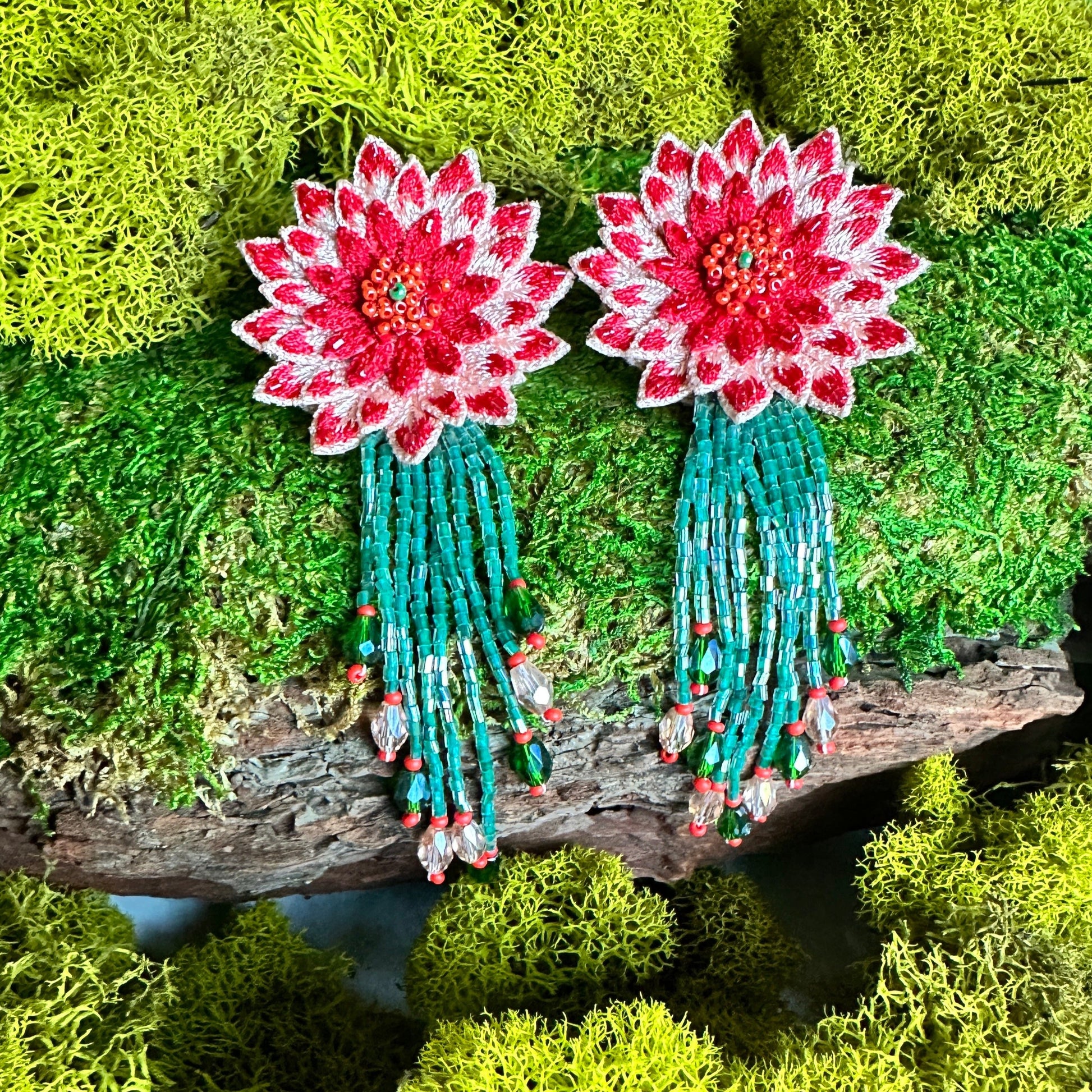 Pair of dahlia design earrings in red, yellow, green, and brown.