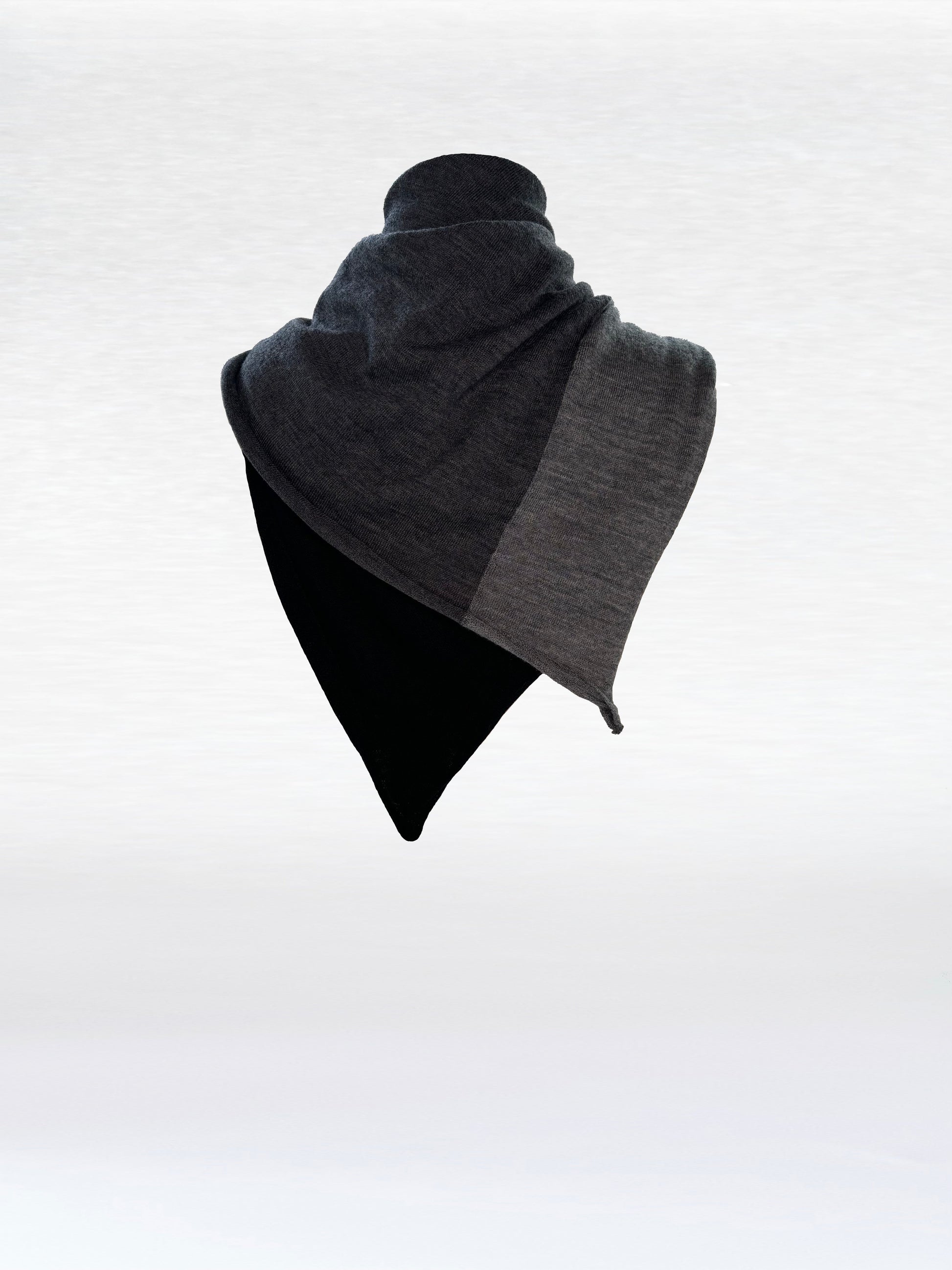 Scarf in black, charcoal, and light grey shaped as if wrapped around a mannikin.
