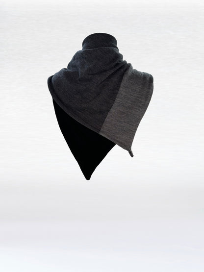 Scarf in black, charcoal, and light grey shaped as if wrapped around a mannikin.
