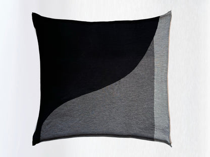 Scarf in black, charcoal, and light grey folded in a square.