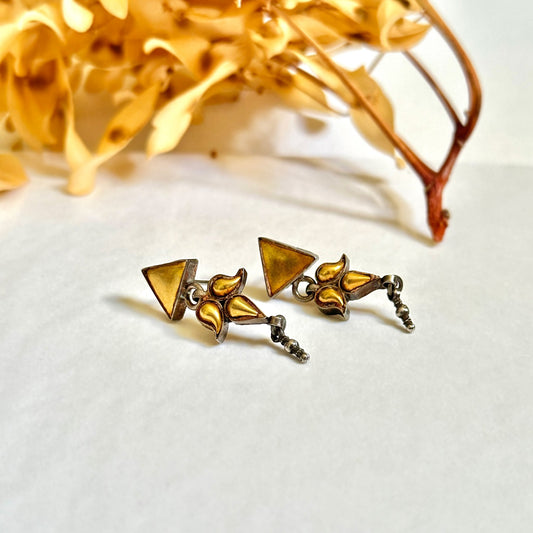 Pair of gold foil earrings with geometric design.  Gold leaf branch at top of image.