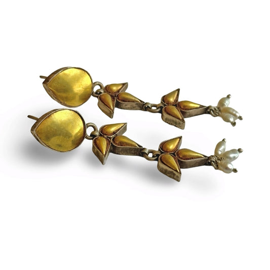 Pair of gold foil post earrings with geometric design laying on side.