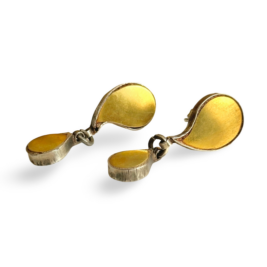 Pair of gold foil earrings with tribal design.
