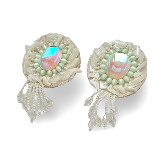 Pair of iridescent white earrings with pink and blue accents.