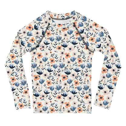 A kids’ rash guard with vibrant pastel flowers, offering UPF 50+ protection and breathable fabric for outdoor play.