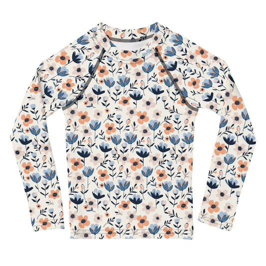 A kids’ rash guard with vibrant pastel flowers, offering UPF 50+ protection and breathable fabric for outdoor play.
