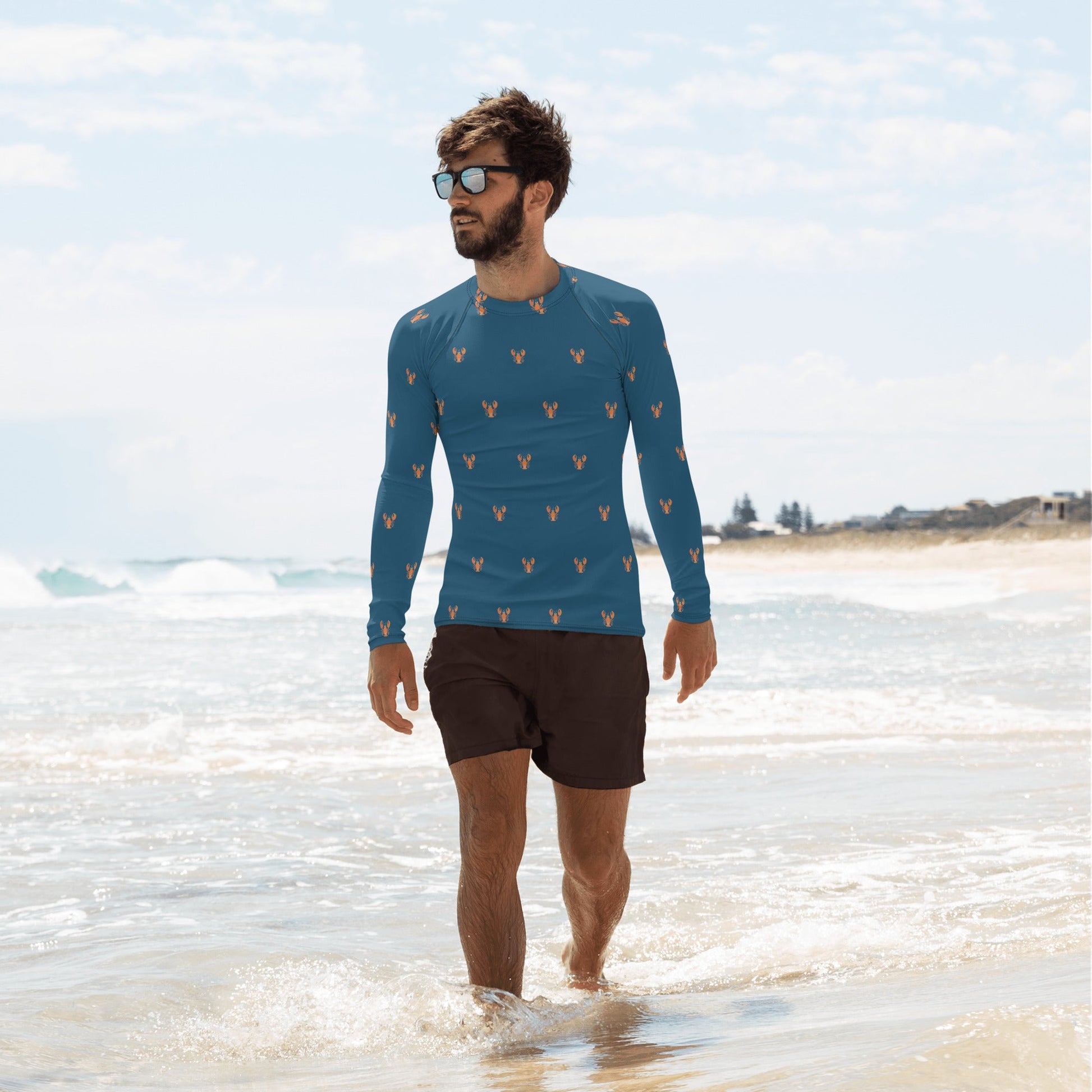 A men’s rash guard with a lobster-themed design, highlighted in red and navy blue, shown from the front