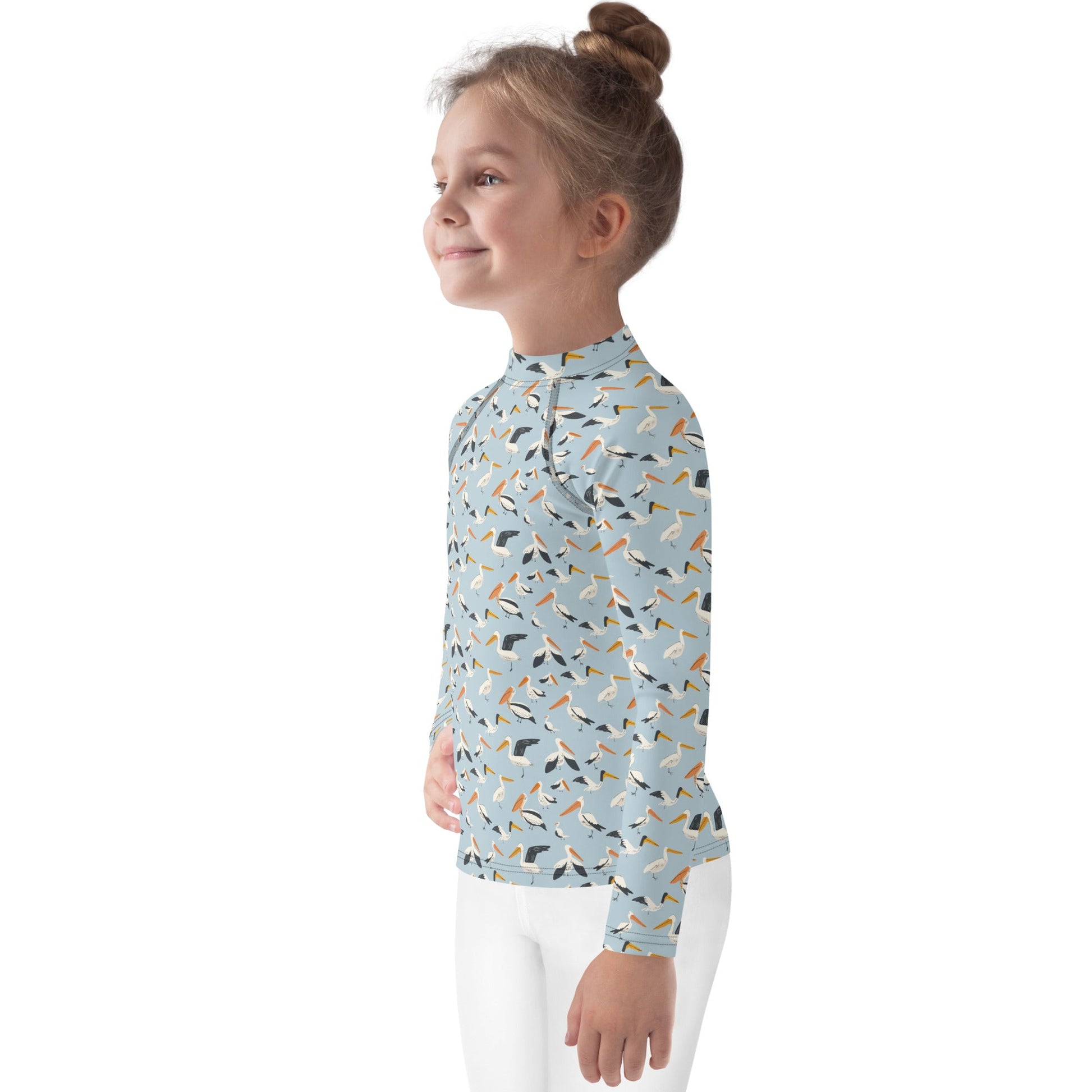 A UPF 50+ kids’ rash guard with a playful pelican design, made from sustainable materials for comfort and protection.