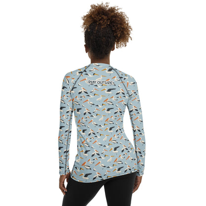 A women’s pelican-print rash guard, shown from the back with a coastal-inspired design for sun-safe fun.