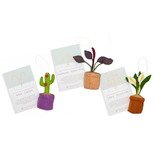 Felt zodiac ornaments of a cactus with Aries astrology card, a rubber plant with Sagittarius card, and a peace lily with Libra card.