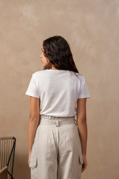 Back view of woman wearing natural colored Yama Cargo Jogger Pants, with her hands at her sides.