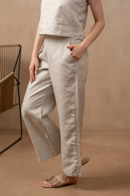 Partial left front view of woman wearing Taru | Wide Leg Ankle Pants, right hand on leg and left hand in pocket.