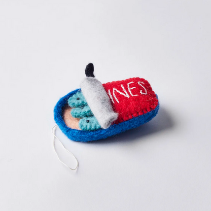 Side view of felt ornament of a can of sardines half open showing three fish.