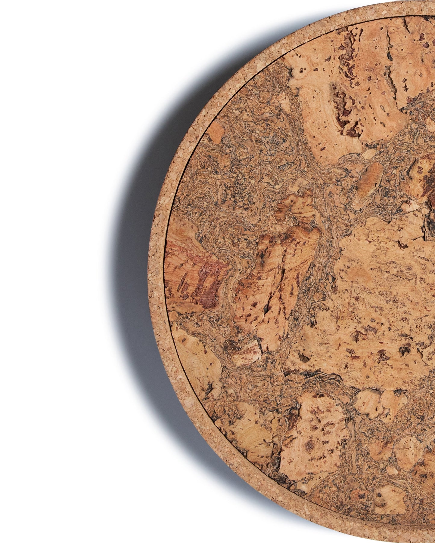 Top view close up of a circular cork Lazy Susan spinning tray with acacia wood base.