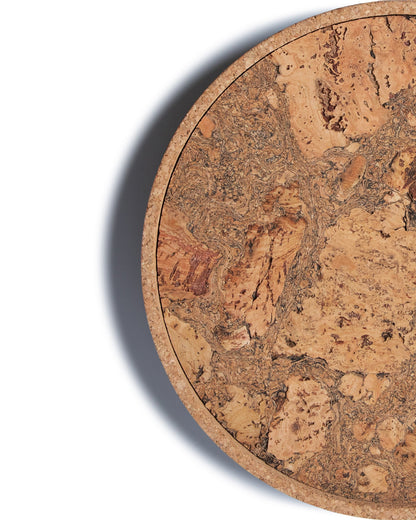 Top view close up of a circular cork Lazy Susan spinning tray with acacia wood base.