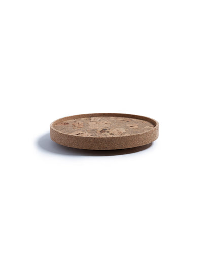 Side view of a circular cork Lazy Susan spinning tray with acacia wood base.