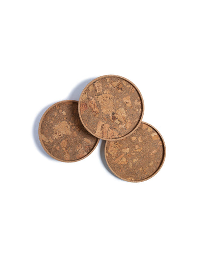 Top view of three circular cork Lazy Susan spinning trays with acacia wood base.