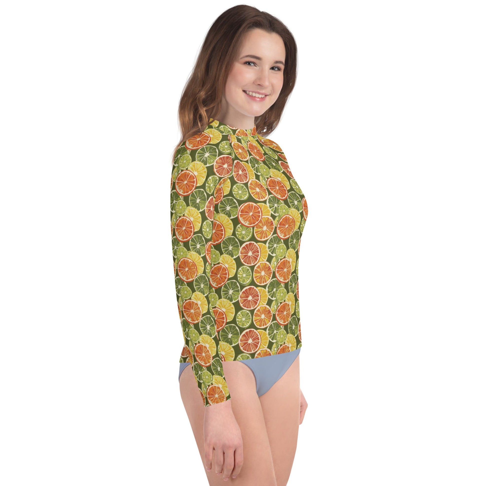 A teen’s eco-friendly rash guard with citrus patterns, made with sustainable materials for all-day sun safety and comfort.