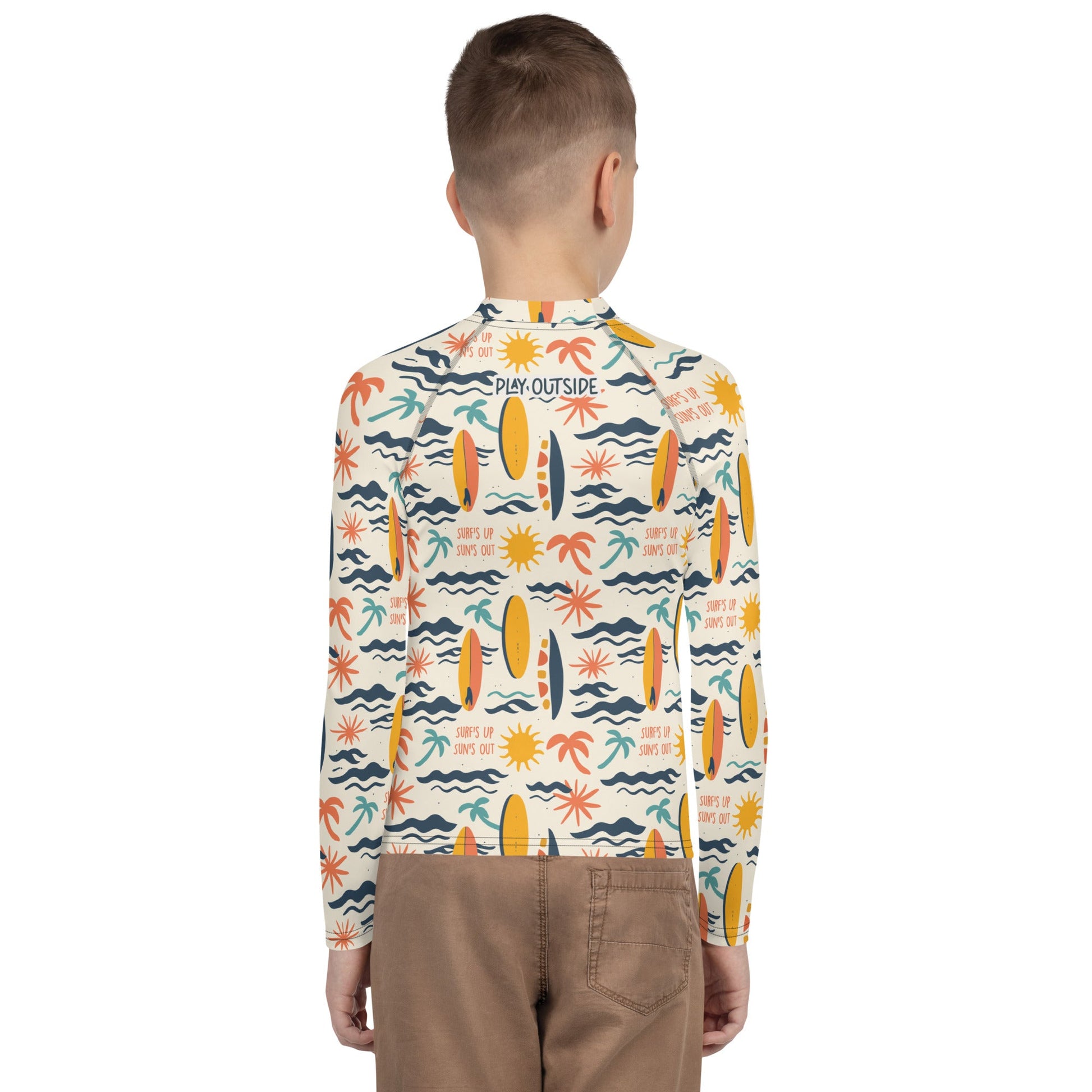 A youth rash guard featuring vibrant surf designs, made with eco-friendly, quick-drying fabric for versatile use.