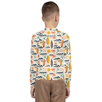 A youth rash guard featuring vibrant surf designs, made with eco-friendly, quick-drying fabric for versatile use.