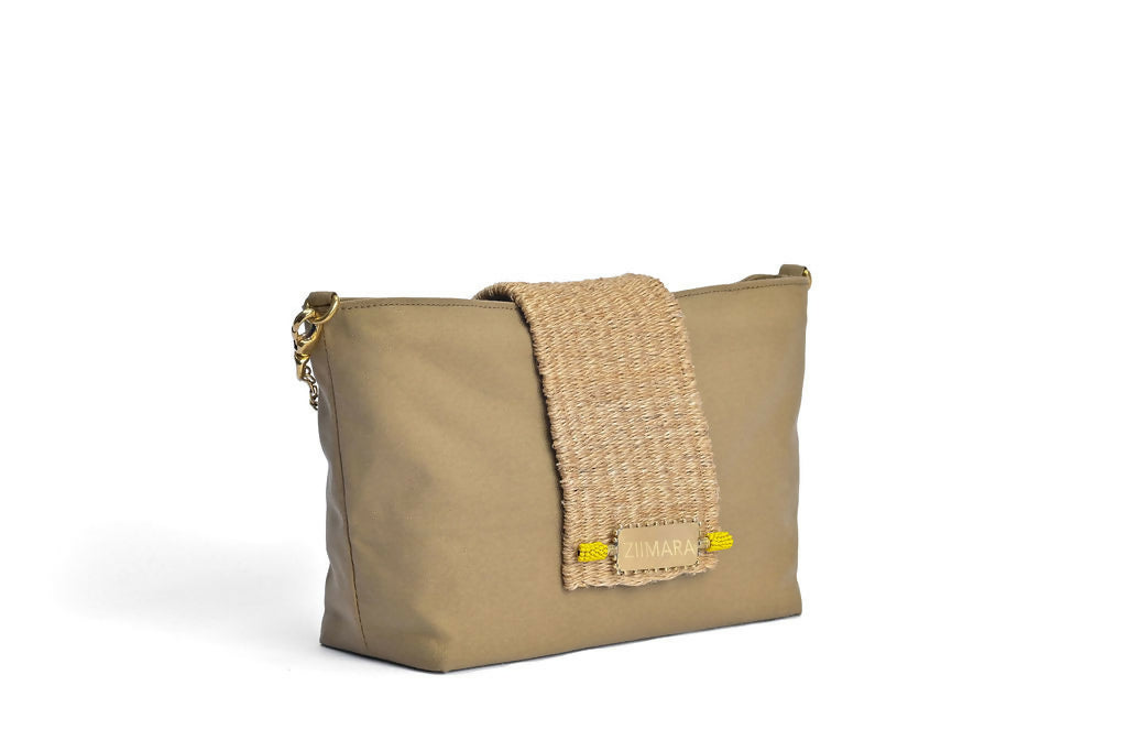 Front side view of sandstone green bag with brass details.
