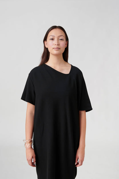 Front view of woman wearing black dress.