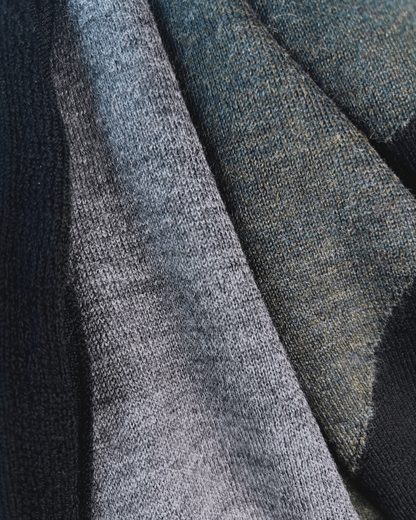 Close Up black, grey, and moss colors of square merino wool scarf.
