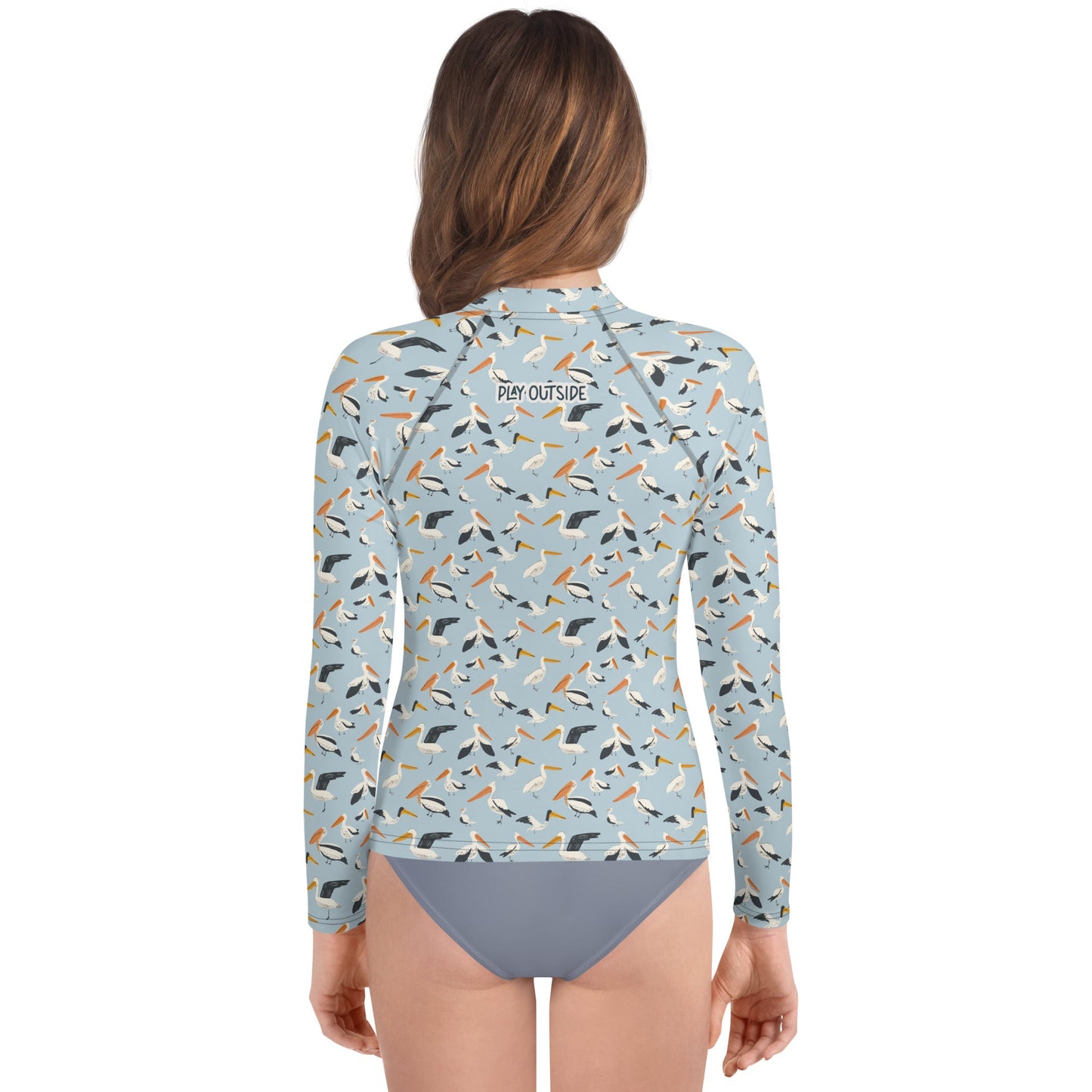 A stylish pelican rash guard for youth, perfect for layering in cooler weather or staying cool while playing in the sun.