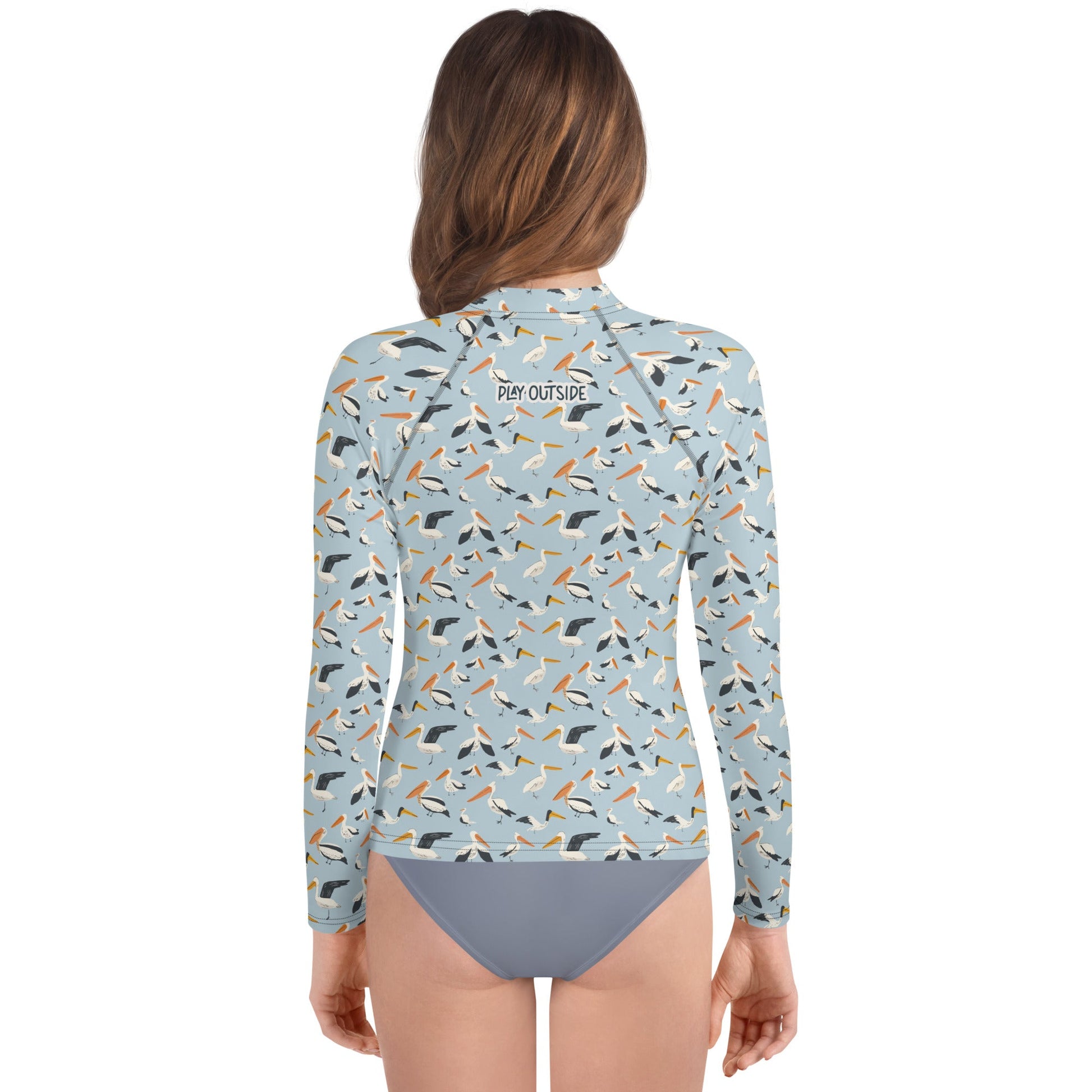 A stylish pelican rash guard for youth, perfect for layering in cooler weather or staying cool while playing in the sun.
