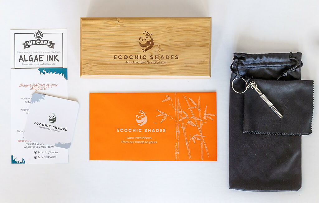 Rectangular bamboo case, soft black pouch, and Ecochic Shades care instructions on a countertop.