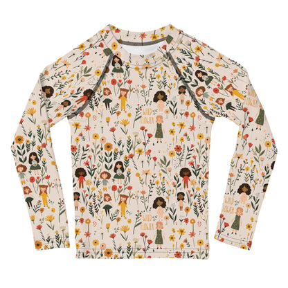 A flat lay of a wildflower-themed rash guard, showcasing the intricate floral and girls pattern