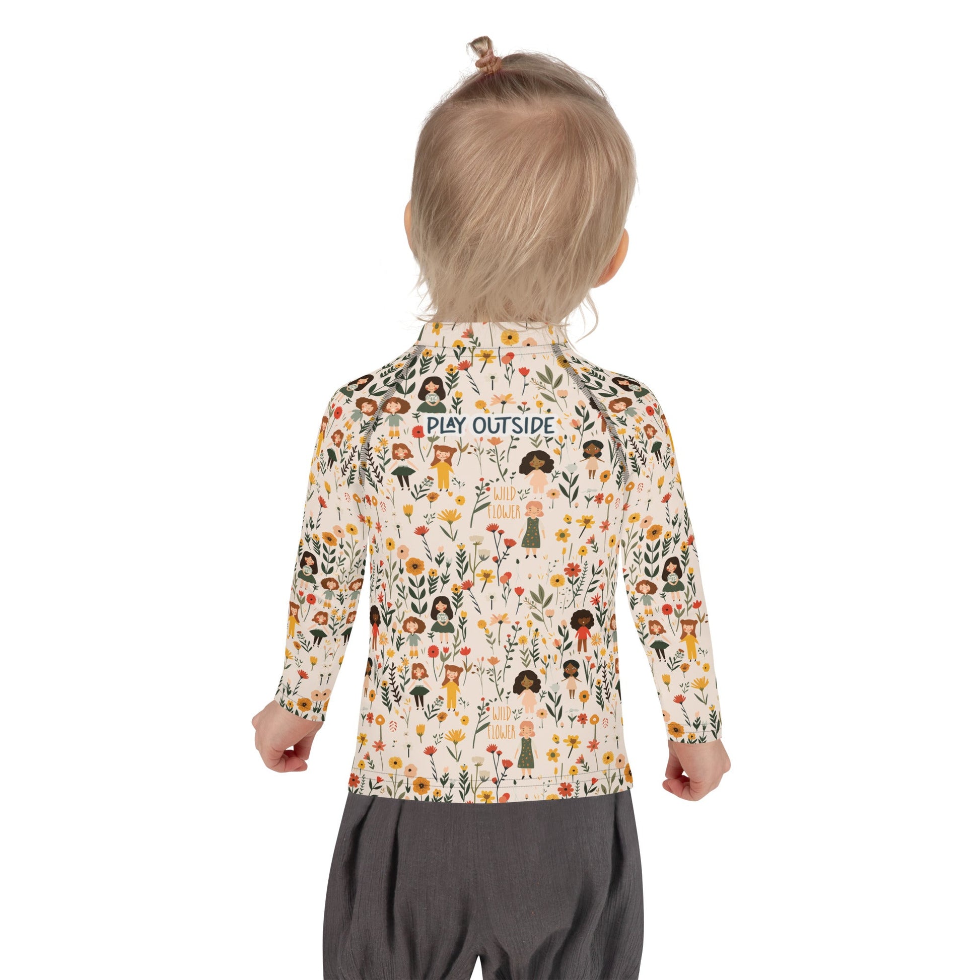 A flat lay of a wildflower-themed rash guard, showcasing the intricate floral and girls pattern from the back.


