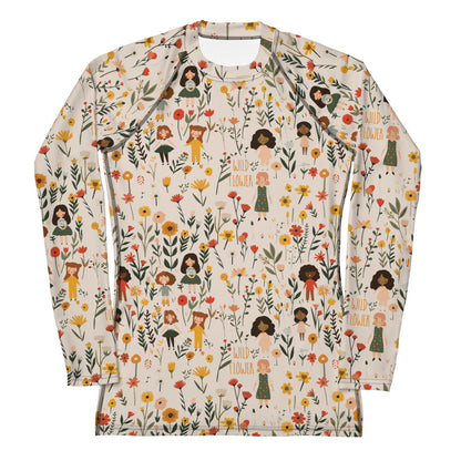 A women’s rash guard featuring a detailed wildflower print in earthy tones, shown from the front.