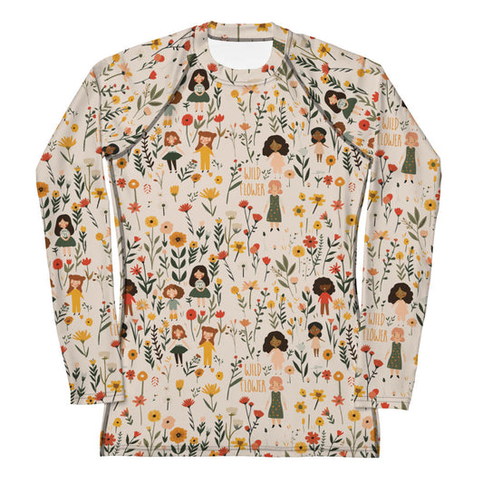 A women’s rash guard featuring a detailed wildflower print in earthy tones, shown from the front.