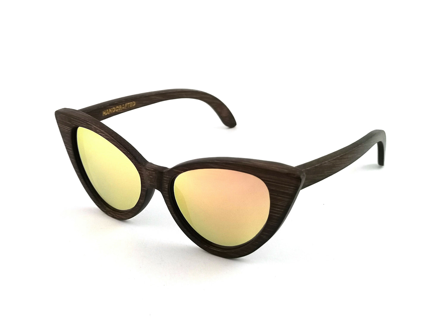 Diagonal view of dark brown bamboo cat eye sunglasses with pink mirrored lenses.