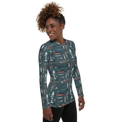 A stylish women’s rash guard with colorful fish patterns, designed for sun protection during hiking, swimming, or boating.