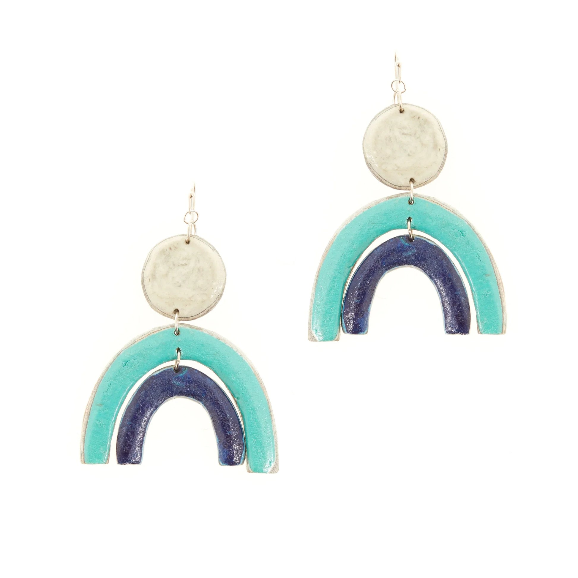 Sterling silver earrings with hanging white circle and a turquoise rainbow arc and dark blue arc below.