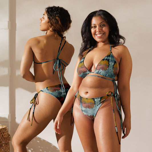 Front and back view of two women wearing orange and dark blue colored print bikini.