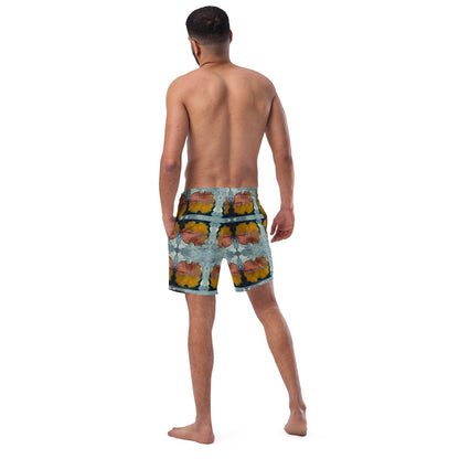 Back view of man wearing multi colored print orange and dark blue swim trunks.