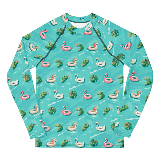 Aqua blue rash guard with images of pink floaty toy unicorns, swans, and Flamingos and green tropical leaves.