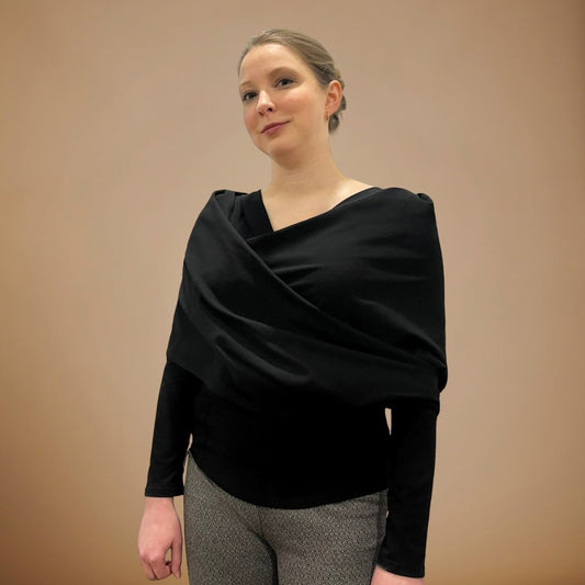 Woman wearing black wrap over a black shirt.
