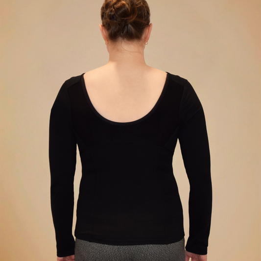 Back view of woman wearing black long sleeve shirt with scoop back.